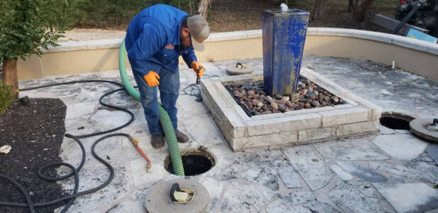 Septic service professionals checking a home in Dripping Springs, TX.